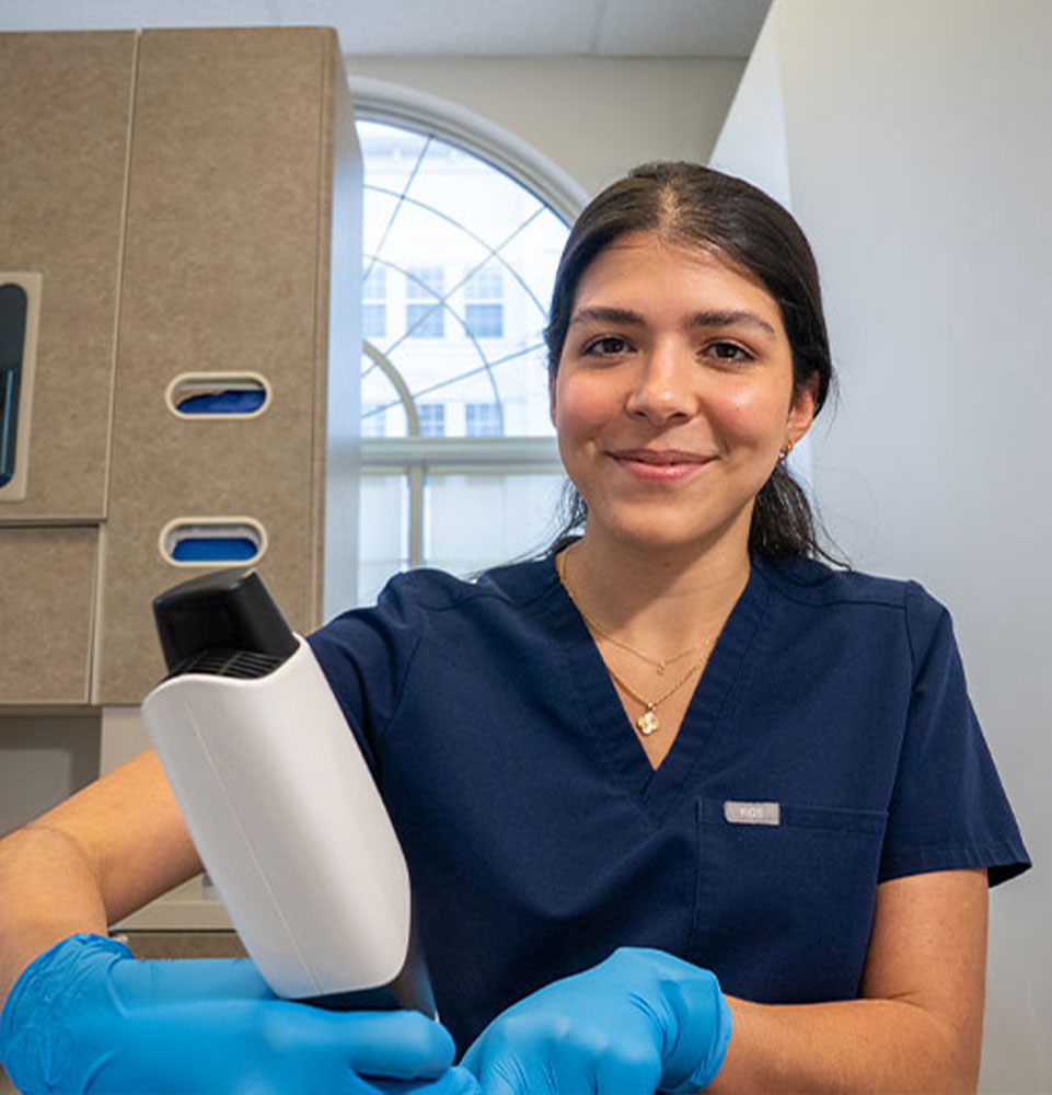 staff member performing dental examination for dental patient