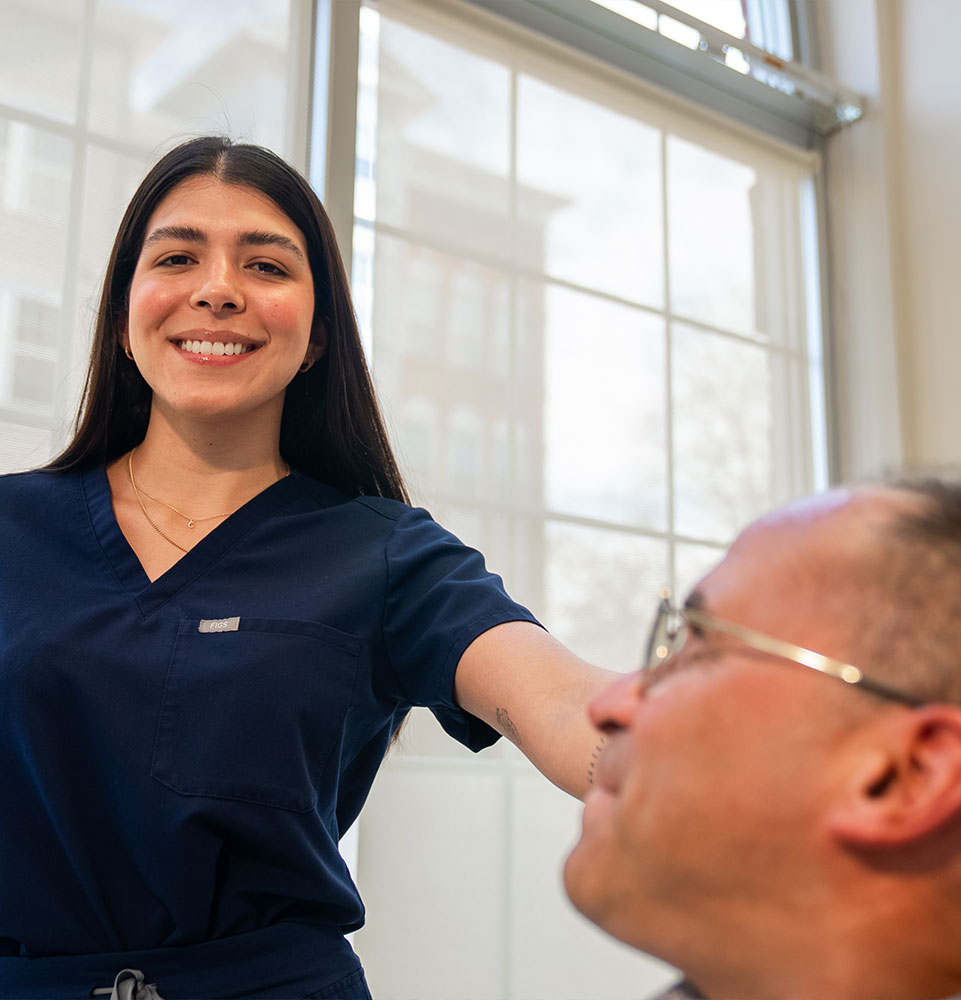 staff member helping patient at the dental center