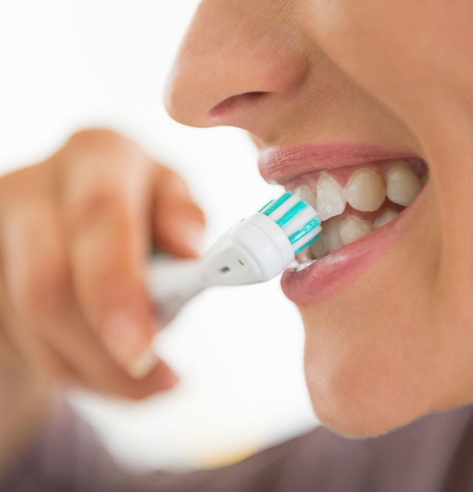 close up of person brushing their teeth
