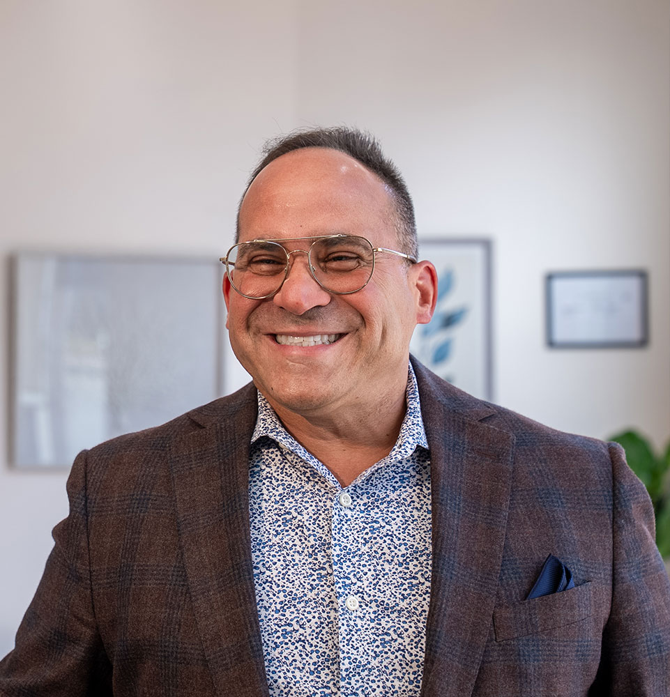 patient smiling and being helped at the front desk of the dental office