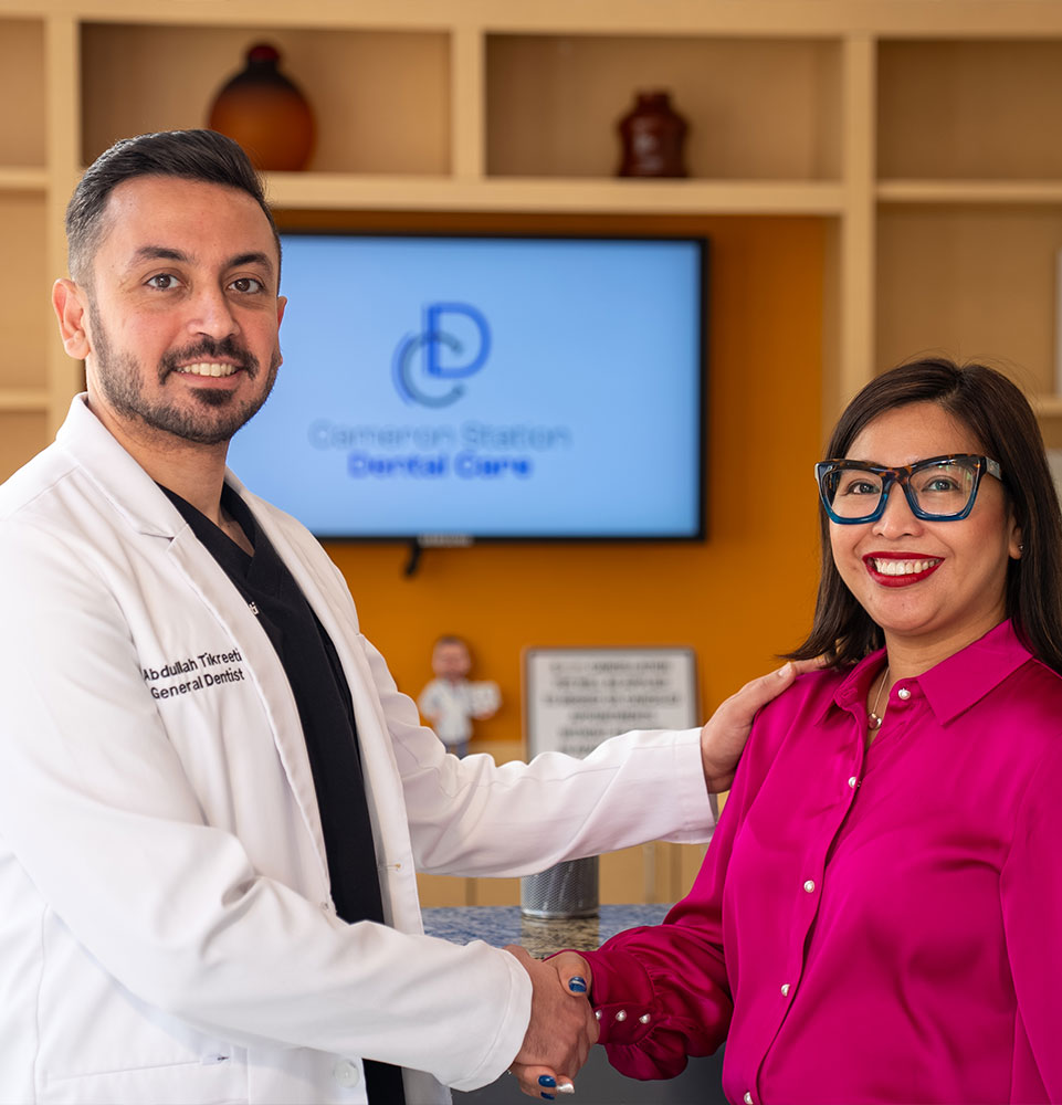 patient and doctor shaking hands after dental procedure with patient