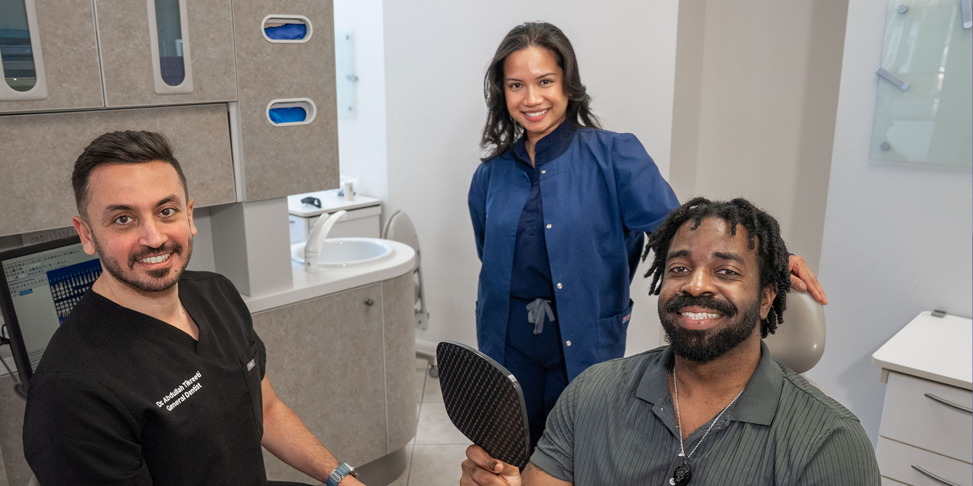 patient and doctor and staff member smiling brightly after treatment