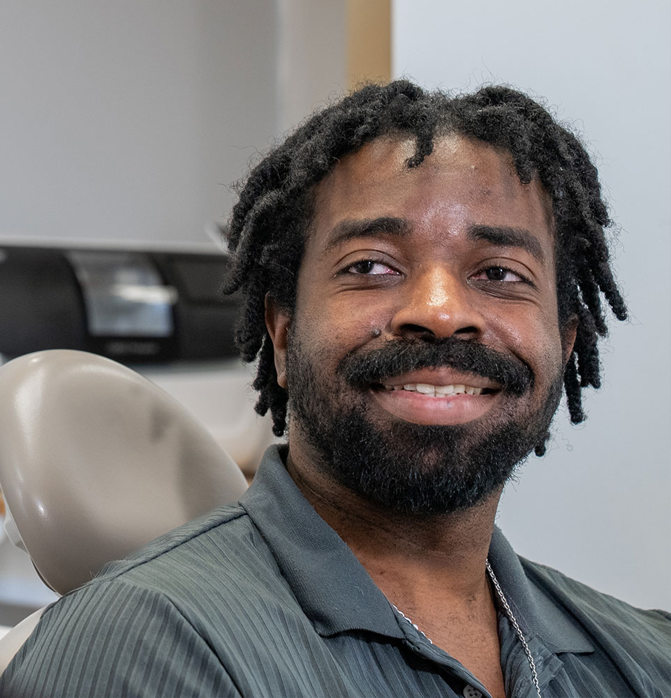 patient smiling brightly after while going over dental procedure information