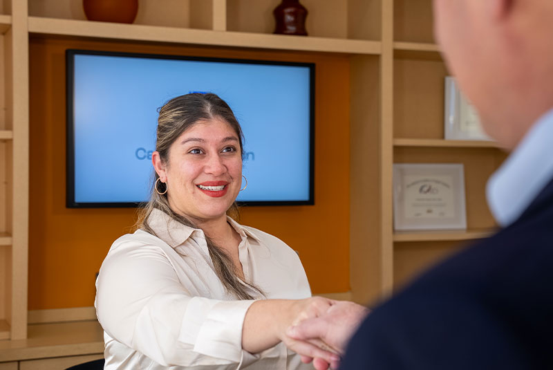 staff member helping patient at the front desk of the dental center
