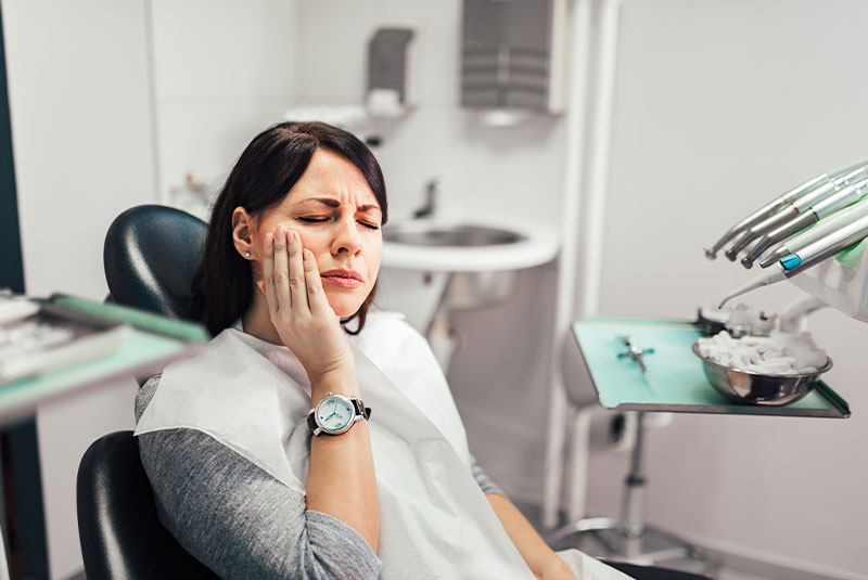 Woman with toothache at dentist office