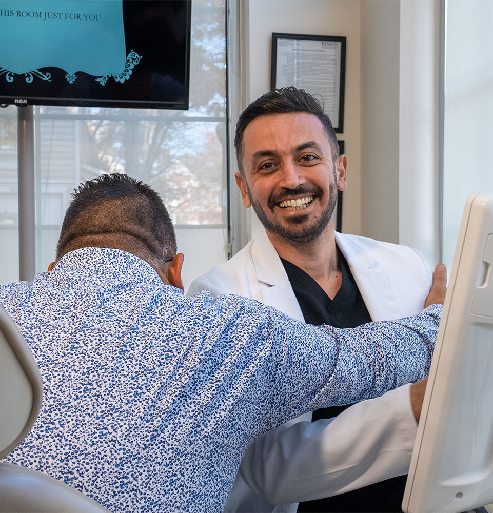patient hugging doctor with doctor smiling brightly